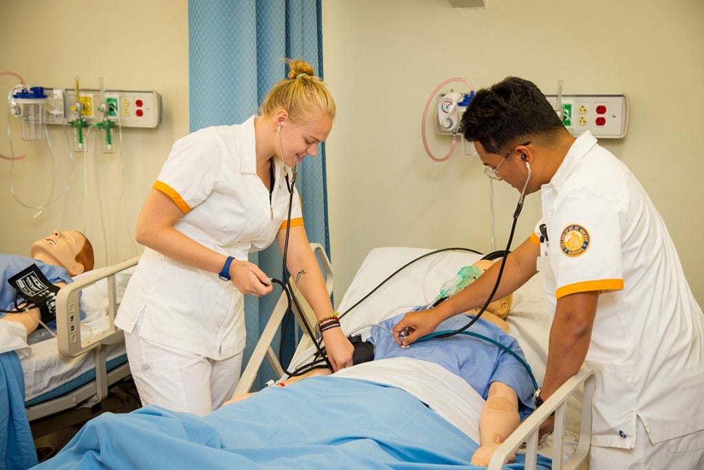 2 nurses in clinical setting with manikin