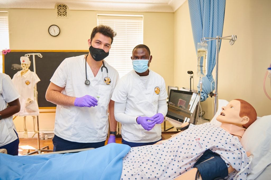 Nursing students practicing on a manikin