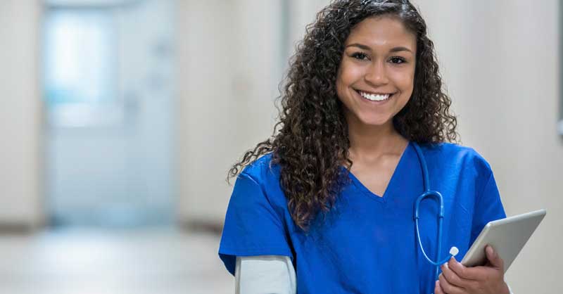 smiling nurse holding a clipboard