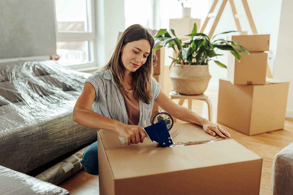 Current image: woman types a moving box closed