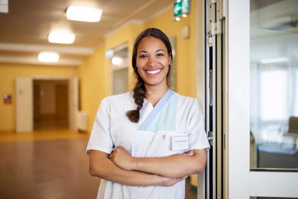 CMS nurse portrait standing by door