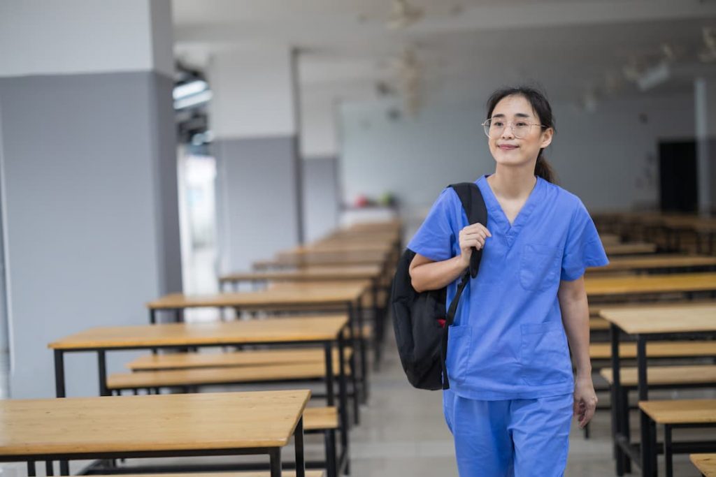Nurse holding backpack