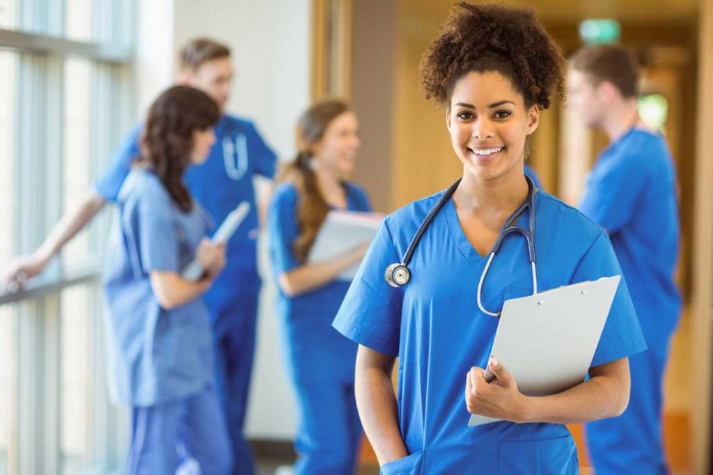 Nurse standing in hallway with a clipboard