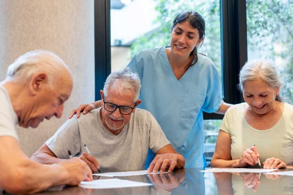 nurse speaking with older patients