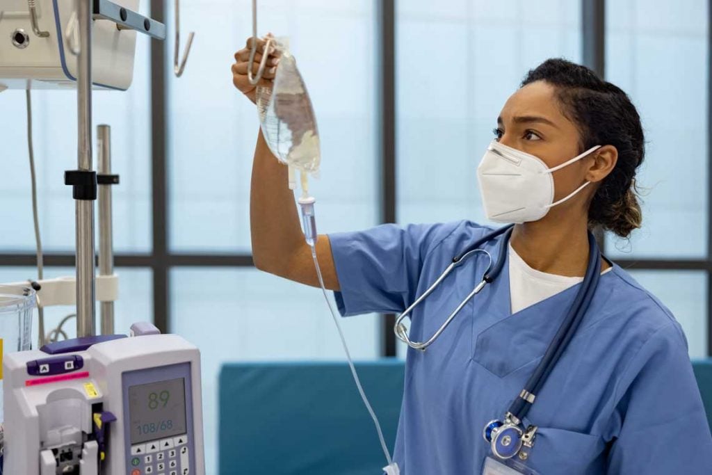 nurse with iv pump