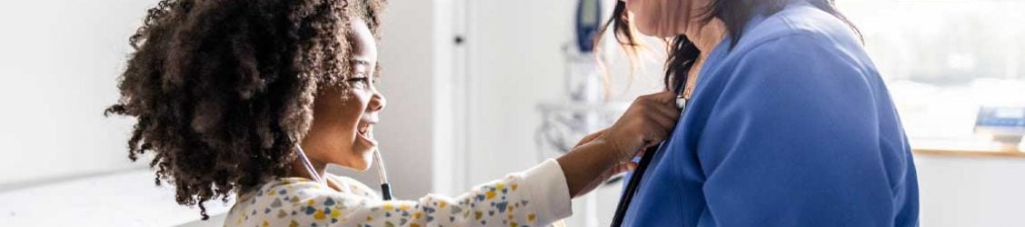 nurse smiling and talking to child patient