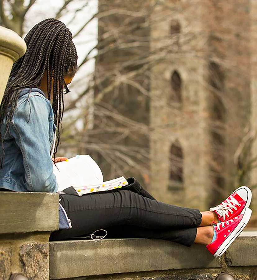 student reading book outside