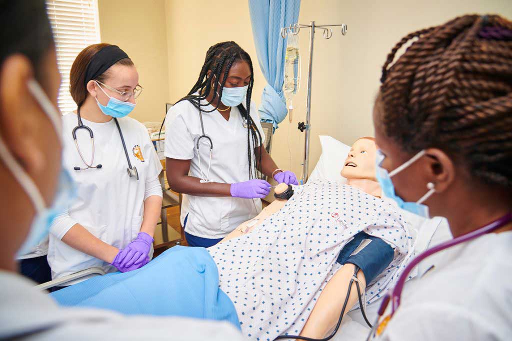 nursing students working in sim lab