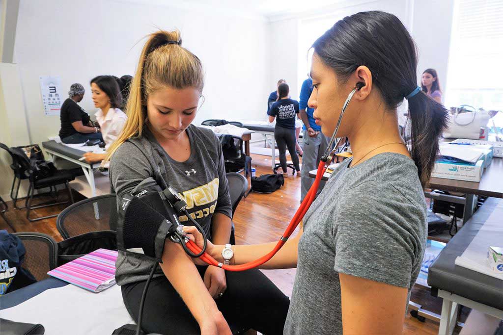 nursing students practicing skills in skills lab