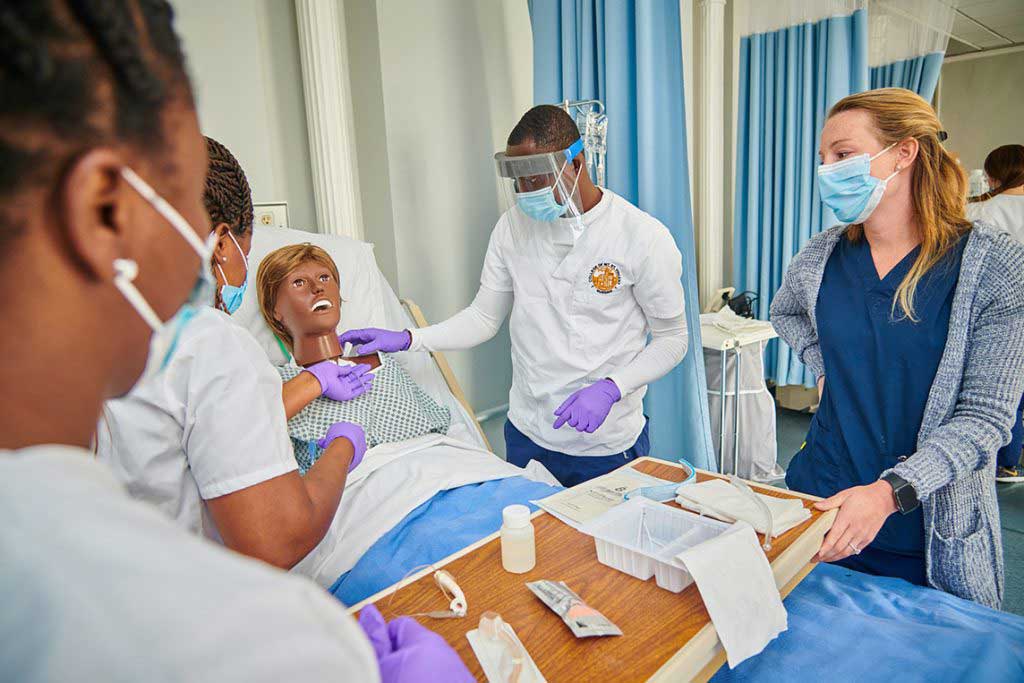 nursing students working in sim lab