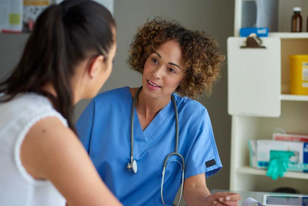 nurse speaking with person in hospital