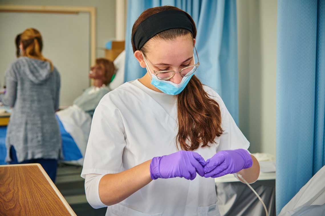 UMSV nursing student using lab equipment