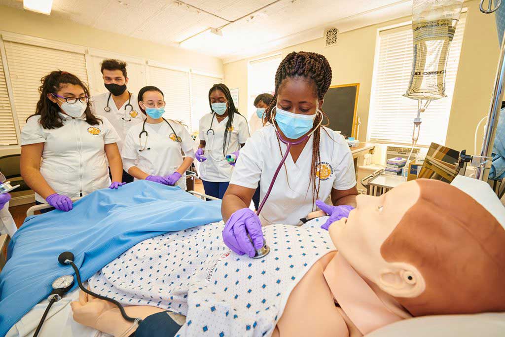 nursing students working in sim lab