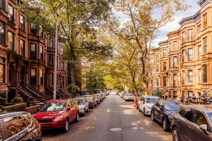 outdoor view of city street with parked cars