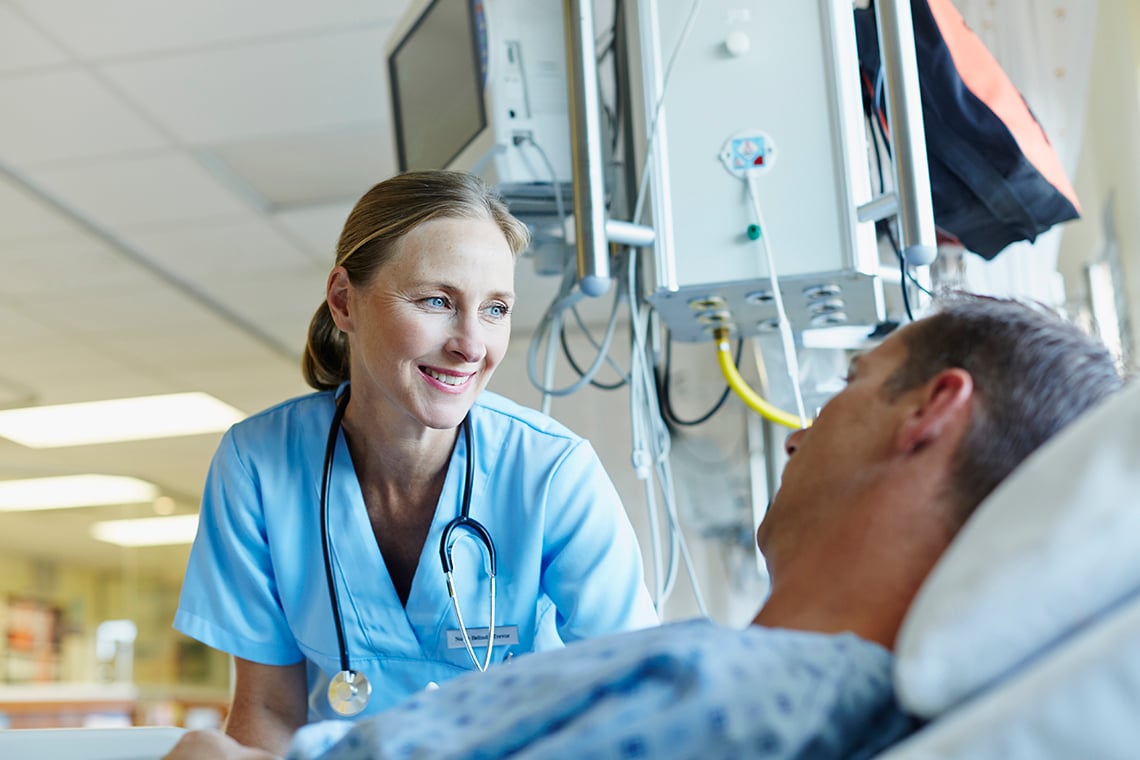 Nurse with patient at bedside
