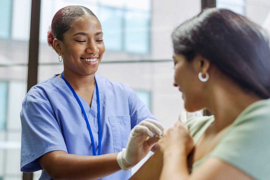 nurse helping patient with bandage