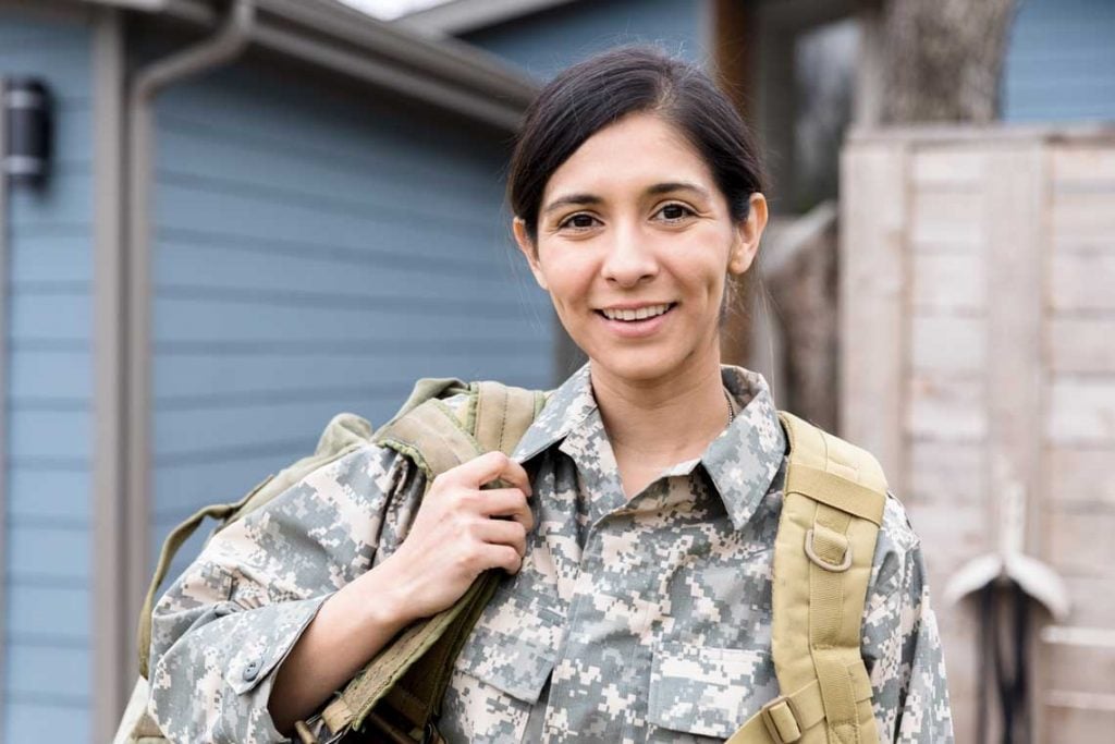 woman wearing military uniform and backpack