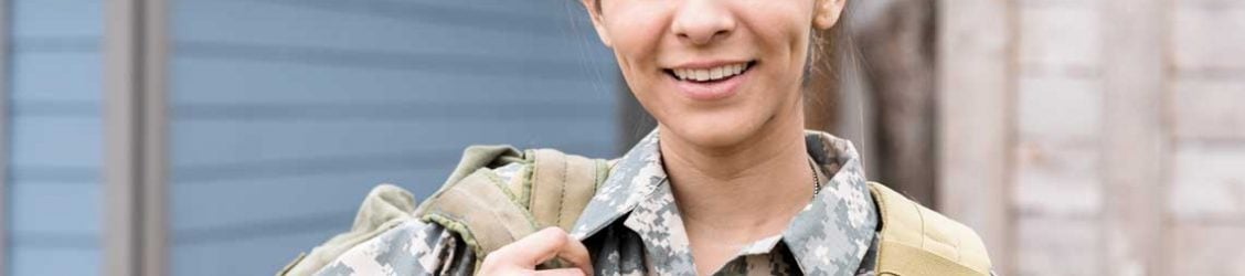 woman wearing military uniform and backpack