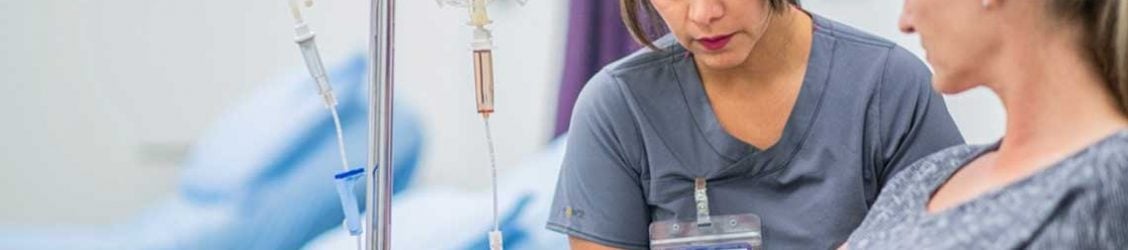 nurse helping patient with IV