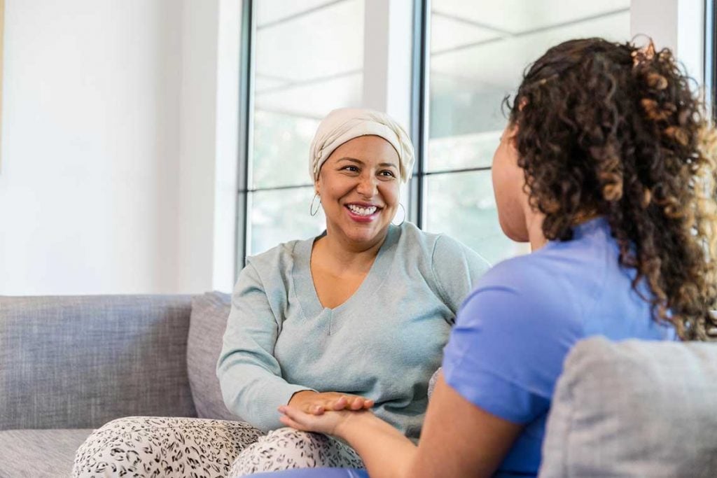 nurse talking with patient on couch