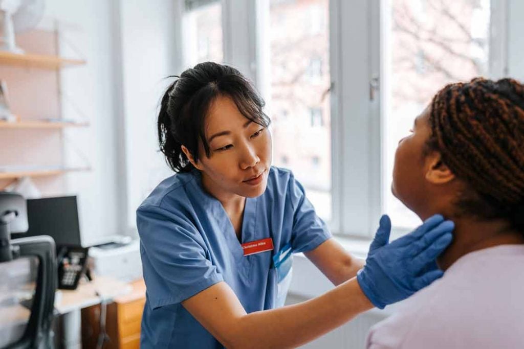 Nursing student checking on patient