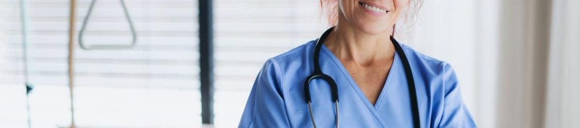 Nurse standing by a bed