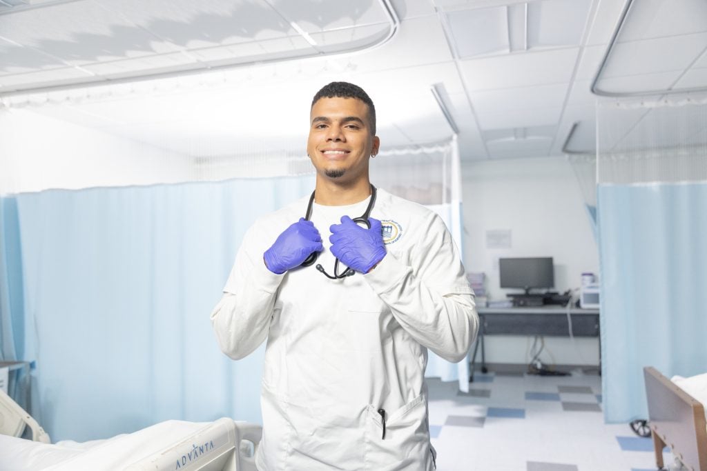 Smiling Mount Saint Vincent nursing student stands in nursing lab