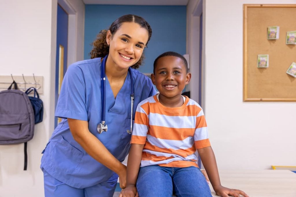 Nurse posing with a little boy